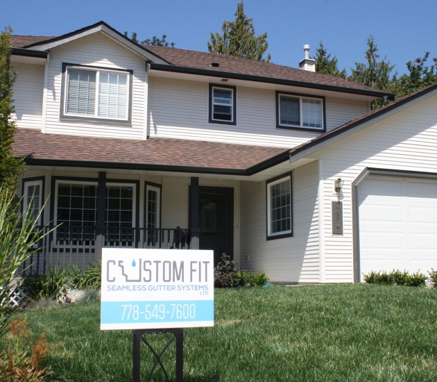exterior of home with signage for Custom Fit Seamless Gutter Systems